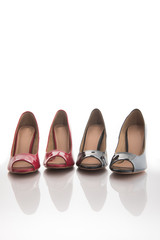 close up of a red high heels   and black high heels isolated on white background.