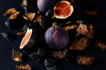 Close-up Picture of Fresh and dried Deep Blue Figs on a Dark Background.