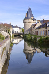 Keep of the fortified gate Saint-Julien on the Huisne river with big reflection at La-Ferté-Bernard, a commune in the Sarthe department in the Pays de la Loire region in north-western France.