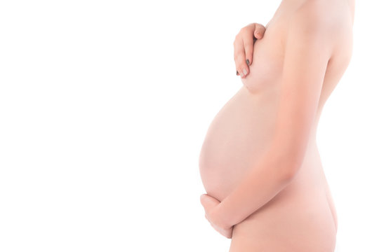 Beautiful naked body of a pregnant woman. Closeup photo.