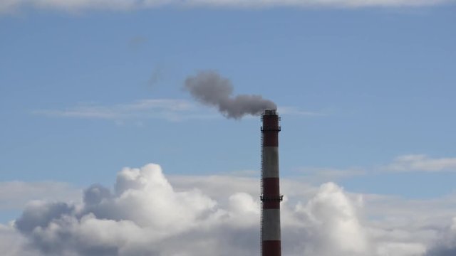 Moving clouds Power Plant pipe with smoke Latvia 4K