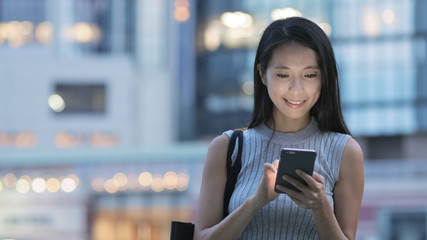 Young woman using mobile phone at night