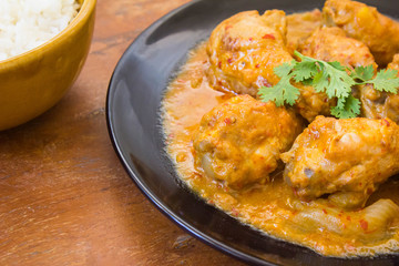 Massaman chicken and rice in the bowl. placed on a wooden table Old brown.,spicy muslim curry muslim food spicy. Eaten with rice or roti