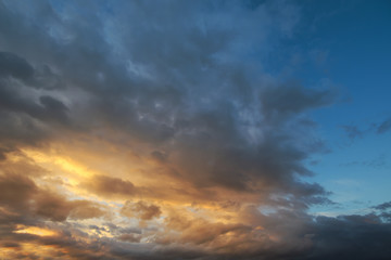 Fototapeta na wymiar Dark sky with blak clouds brings storm rain at the sunset.