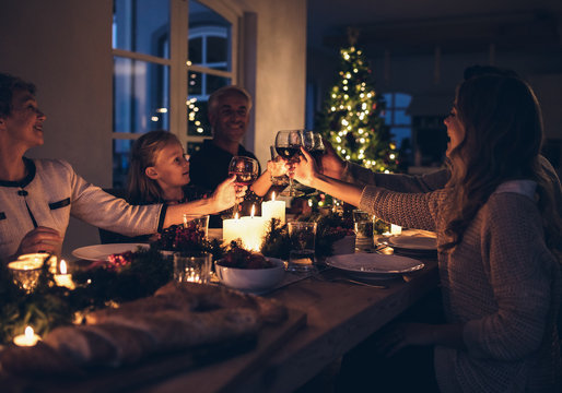 Happy family celebrating christmas together at home - Powered by Adobe