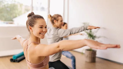 Foto op Plexiglas Woman practicing yoga at gym class © Jacob Lund