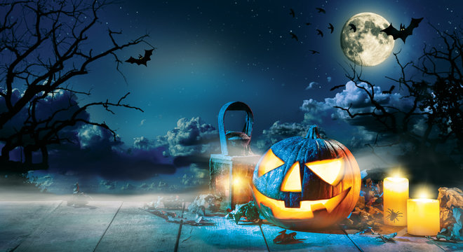 Spooky halloween pumpkin on wooden planks