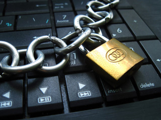 Chain with lock on computer keyboard. It means laptop banned or internet banned. Symbol of computer...
