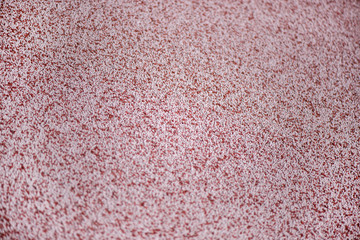 Shot of mixed chemical, artificial nitrogen plant fertilizer granules in factory. Big heaps of mineral pellets creating abstract textures, patterns. Minerals used in agriculture, farms, fields