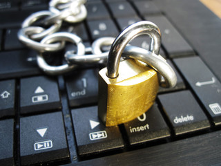 Chain with lock on computer keyboard. It means laptop banned or internet banned. Symbol of computer addiction, games, social networks and so on