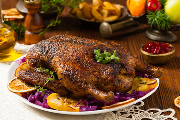 Baked whole duck, served with apples, red cabbage, oranges and roasted fritters.