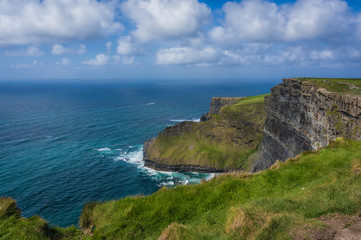 People viewing Aran Isles from Cliffs of Moher