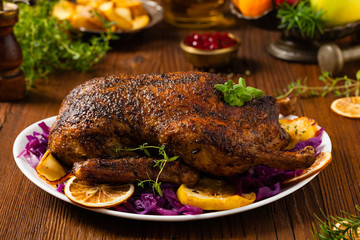 Baked whole duck, served with apples, red cabbage, oranges and roasted fritters.