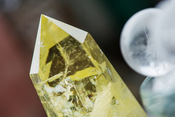 Macro shot of citrine stone and crystal balls on colorful background. Yellow crystal, smokey quartz...