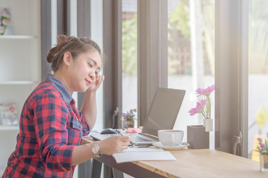 Close Up businessmen working at a coffee shop with a document with a smartphone and a laptop computer.