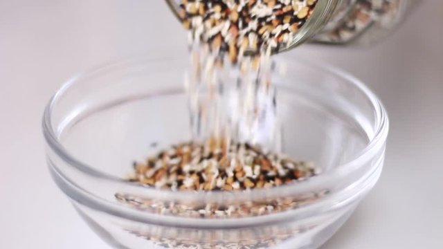 Pouring glass can with spice seeds