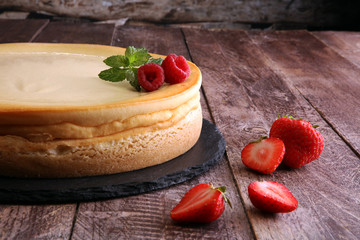 Homemade cheesecake with fresh strawberries and mint for dessert - healthy organic summer dessert pie cheesecake. Vanilla Cheese Cake.