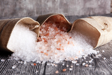 sea salt and himalayan in burlap. Crystals of salt on table