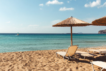 Beach sunbed and parasol overlooking turquoise water