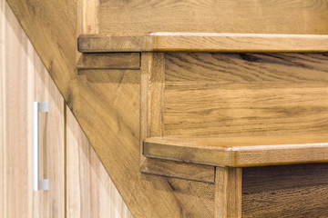 Detail close-up image of wooden oak stairs in house interior