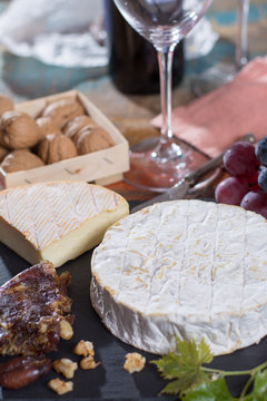 Famous French fresh soft cheese - camembert, delicious dessert with nuts and dried fruits