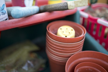 Close up of flower pots and tools in a green house or potting shed