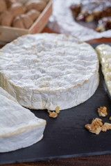 French soft cheeses - camembert, marcaire, munster, brie - delicious dessert with nuts and dried fruits