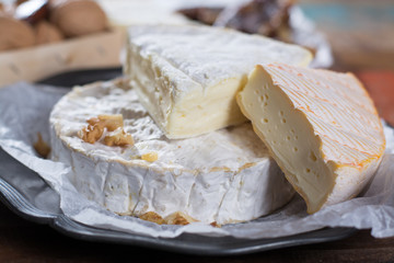 French soft cheeses - camembert, marcaire, munster, brie - delicious dessert with nuts and dried fruits