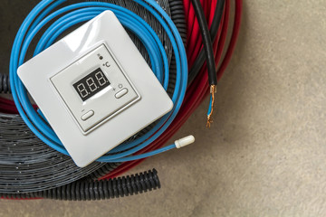 Heating floor system, cables and control panel. Renovation and construction concept. Comfort house.