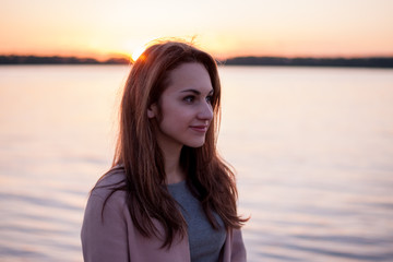 Girl at sunset at the river