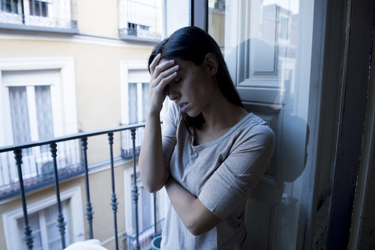 desperate Latin woman at home balcony looking destroyed and depressed suffering depression