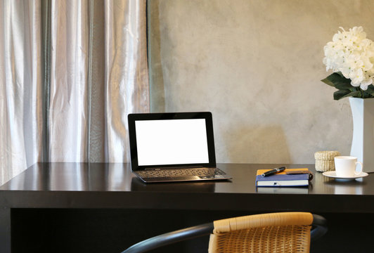Laptop On the black desk In the office at home minimalism style loft cement wall in background