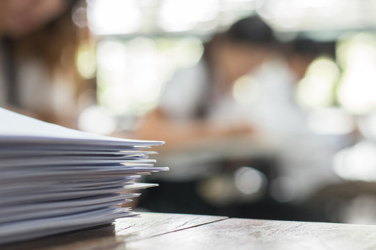 Exam Answer Sheet Or Application Paper Blurry View On Table In Examination Room With Blur Education Background Of School University Students Taking Exam Test Writing Answer In Seat Row With Stress