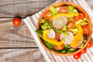 close up salad on wooden table and cotton napkin.