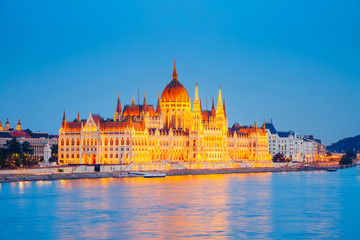 Fototapeta na wymiar Evening view of Hungarian Parliament with Margit bridge. Famous place Budapest, Hungary, Europe.