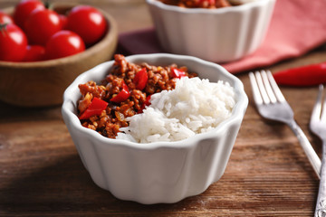 Chili Con Carne with rice in bowl on table