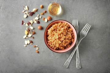 Bowl with boiled lentils on grey background