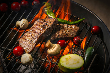 Delicious cooked meat with vegetables on grill