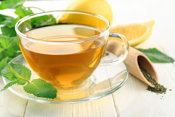Cup of mint tea on table