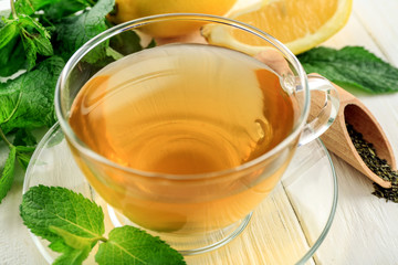 Cup of mint tea on table, closeup