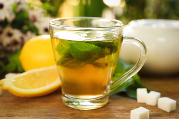 Cup of mint tea on table
