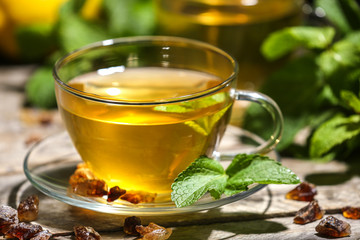 Cup of mint tea on table