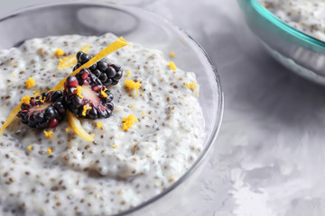 Glass bowl with delicious chia seed pudding on table