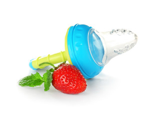 Baby's nibbler and ripe strawberry on white background
