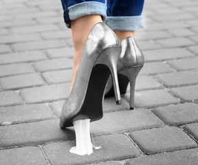 Foot stuck into chewing gum on street. Concept of stickiness