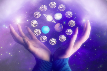 zodiac symbols with various planets and female hands like an astrology concept