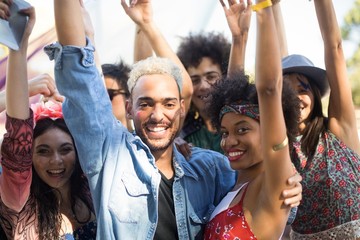 Portrait of happy friends enjoying during music festival