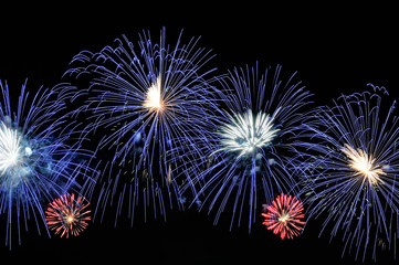 Obraz premium Amazing blue, white and red fireworks on dark background