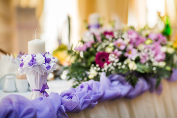 Wedding table setting candle on the table. Flowers and candle on the table.