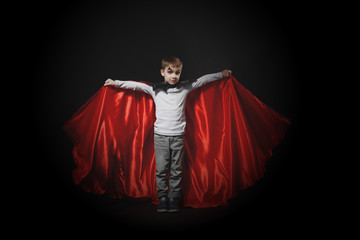 Boy in vampire costume waves his cloak